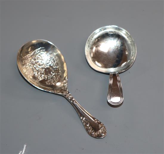 A George III silver Old English thread pattern caddy spoon and a late Victorian caddy spoon with picture bowl.